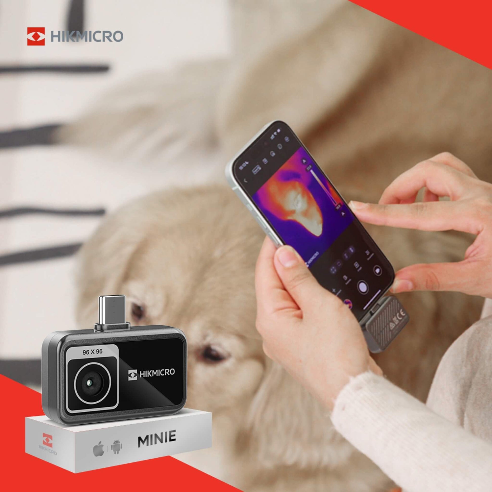 HIKMICRO MINIE thermal imaging device on a stand with a phone displaying thermal imaging on a red background
