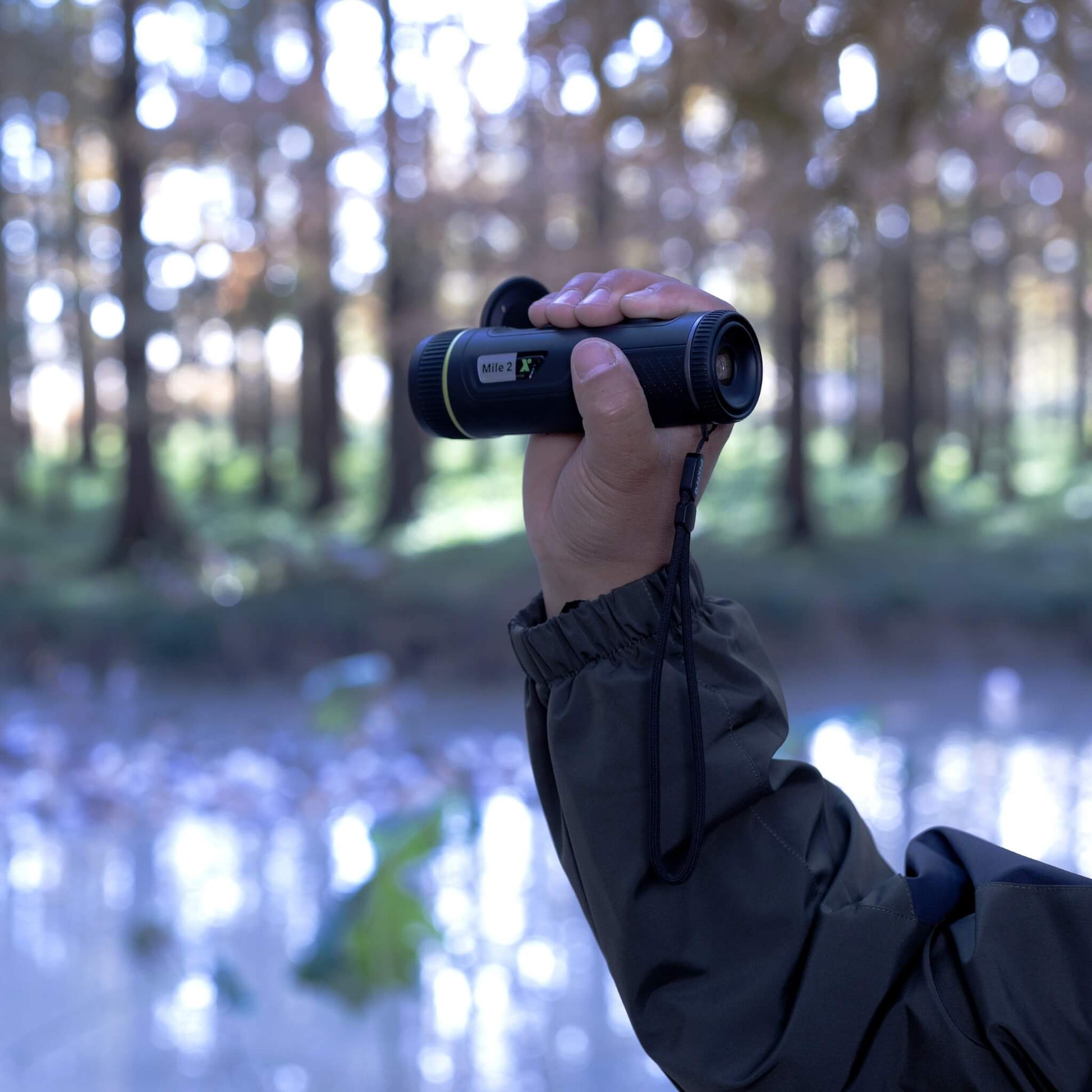 he Pixfra Mile 2 M207 Thermal Monocular in hand demonstrating its IP67-rated durability and portable nature for outdoor use.