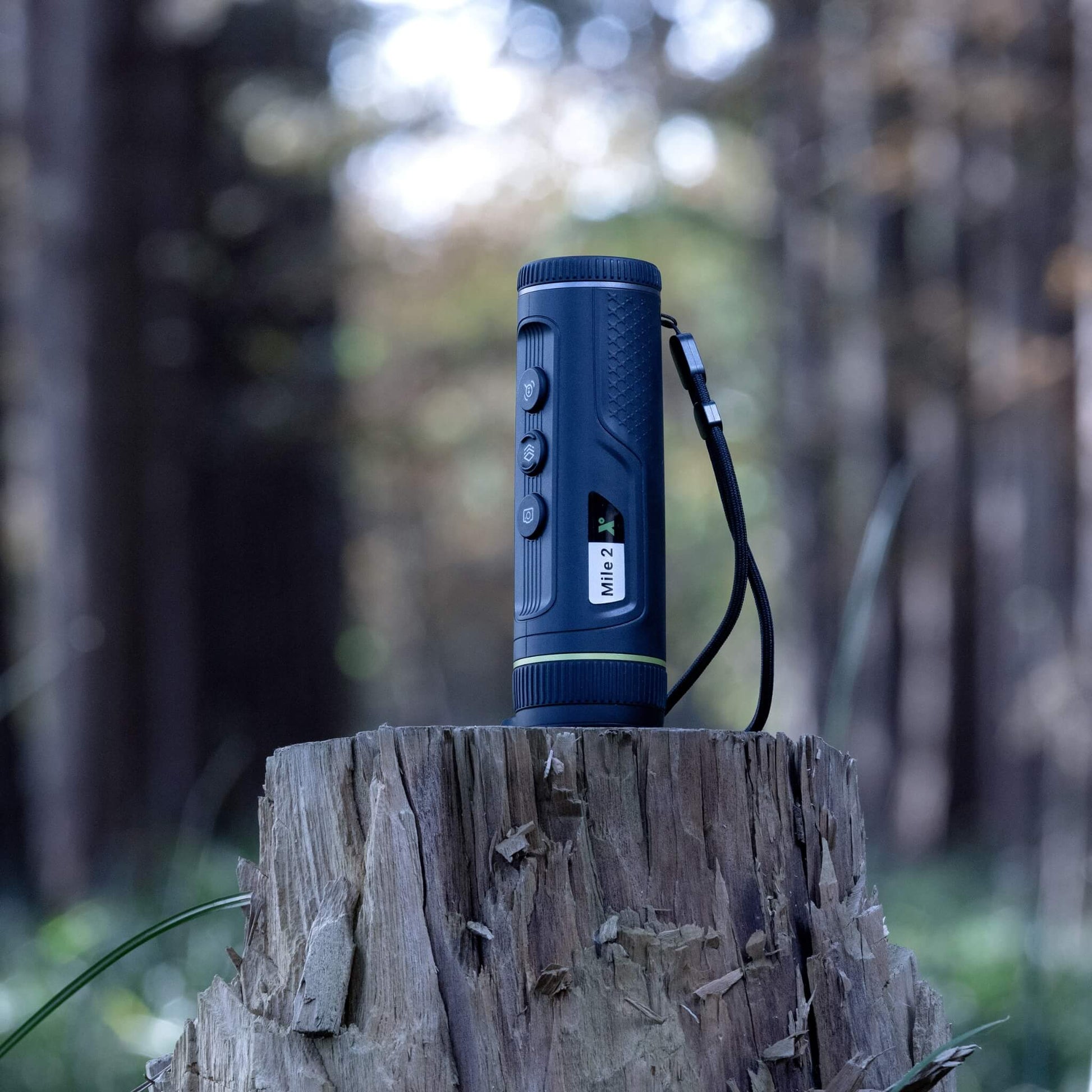 The Pixfra Mile 2 M425 Thermal Monocular positioned in a field, highlighting its long-range 1,300m detection capability and rugged IP67-rated construction for outdoor professional use.