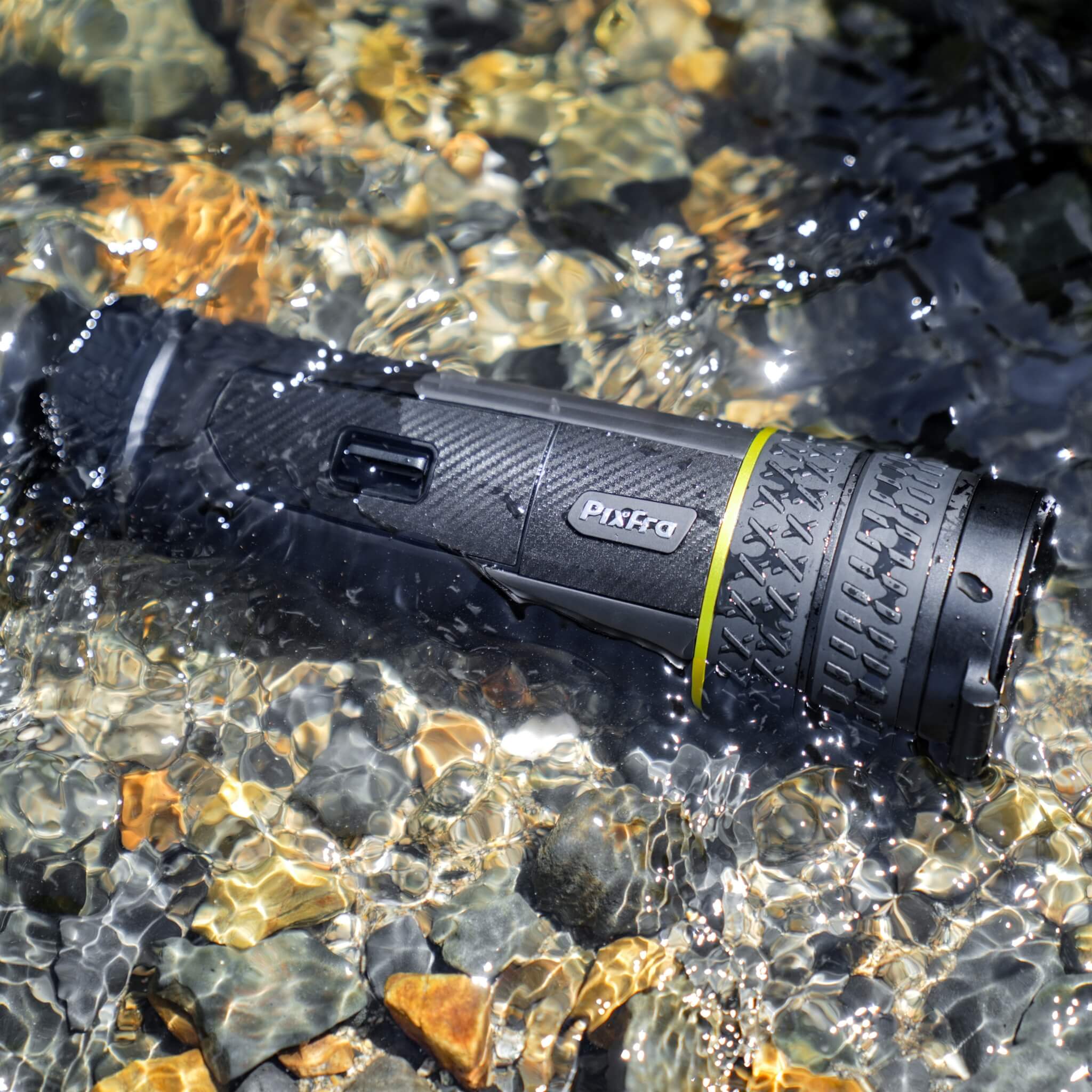 Pixfra Sirius S650 submerged in water showing the lens cap and cylindrical body to demonstrate the IP67 waterproof rating.