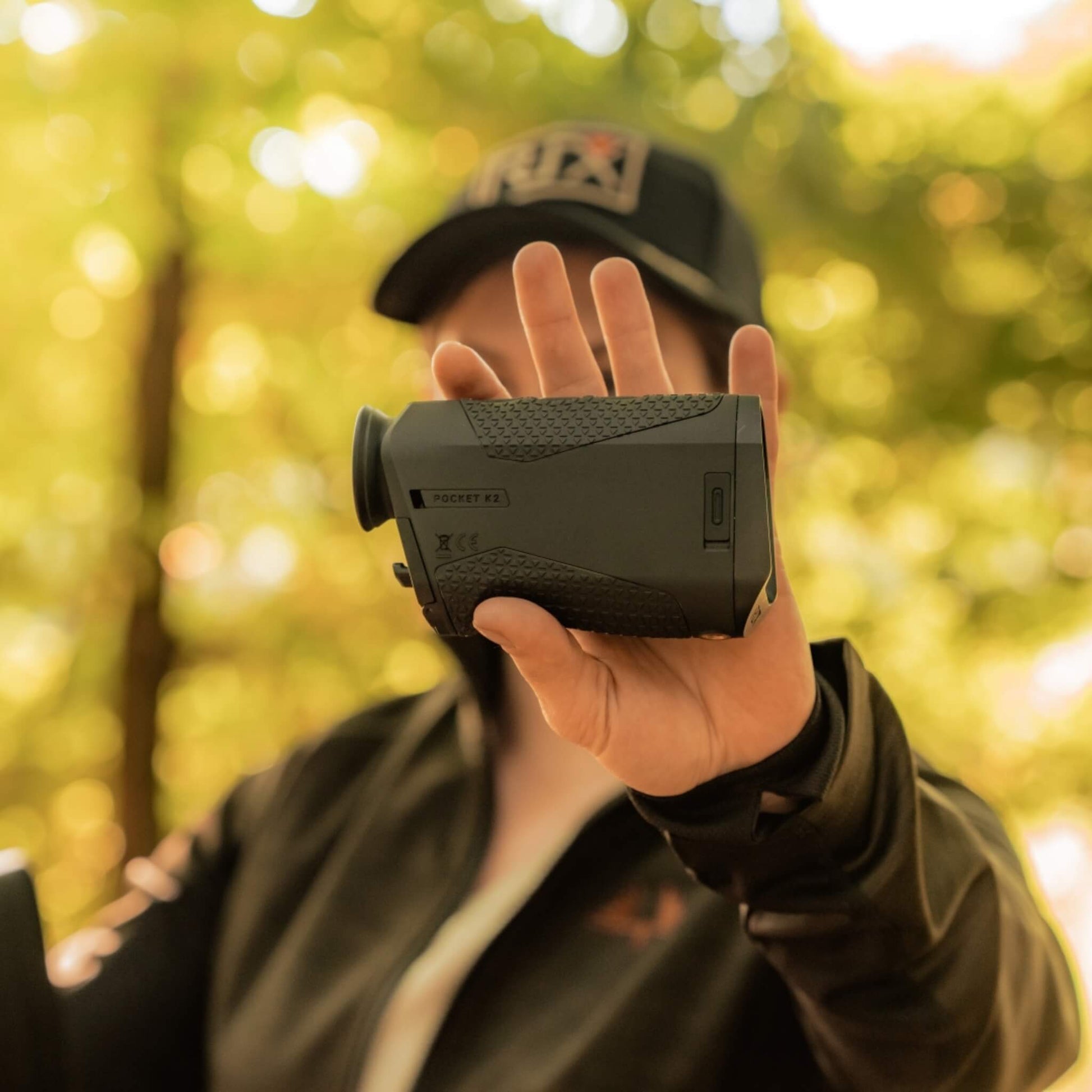 The RIX Pocket K2 being held in one hand, showcasing its 200g featherlight weight and pocket-sized portability for everyday professional security and outdoor use.